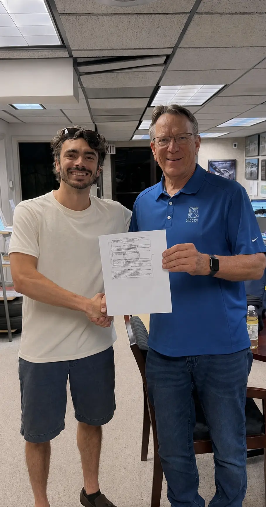 Flight instructor congratulating student pilot on certificate