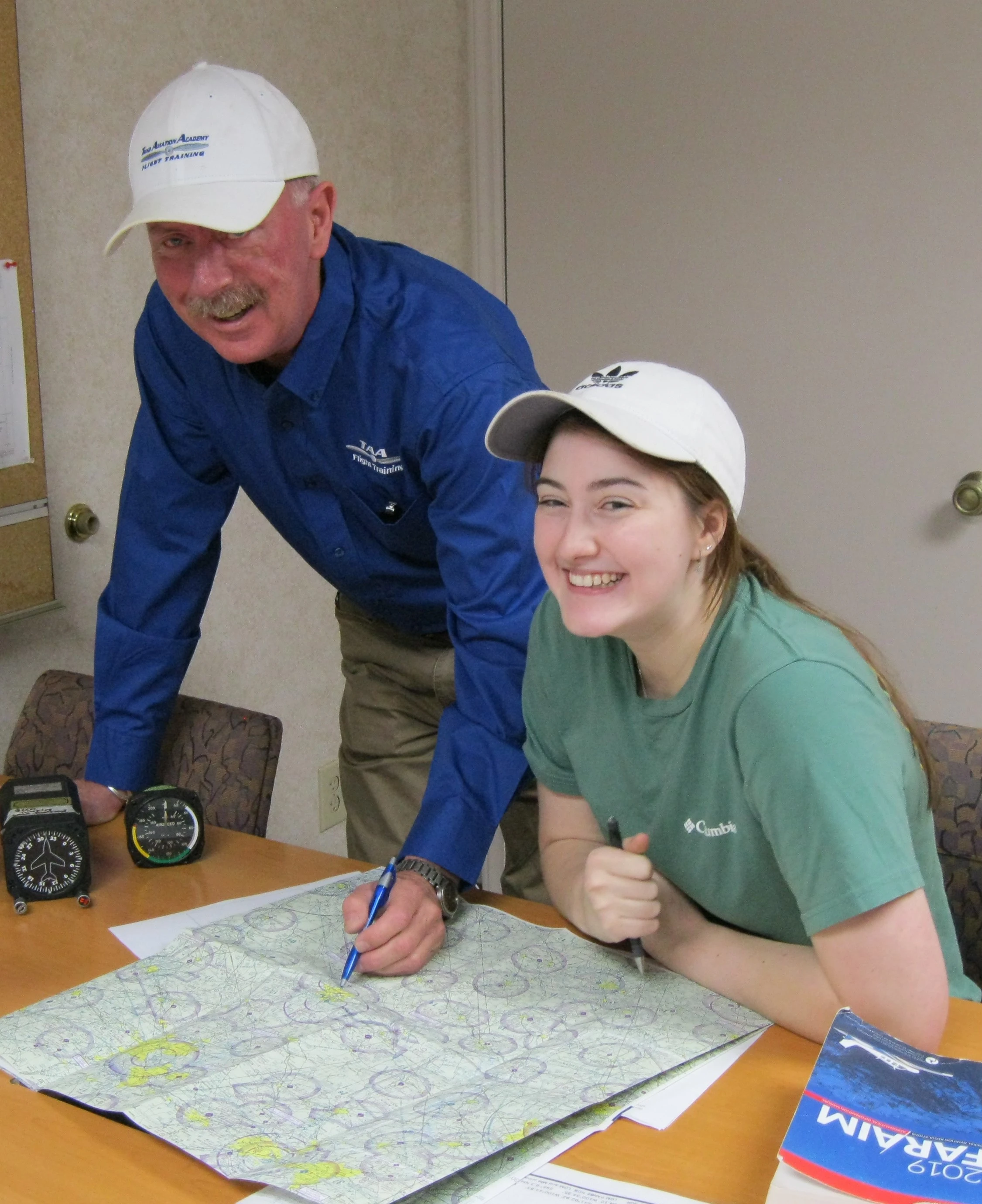 Flight instructor and student inspecting a Cessna