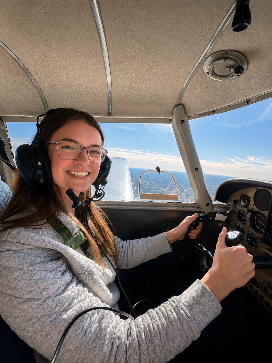 Student pilot smiling from the cockpit