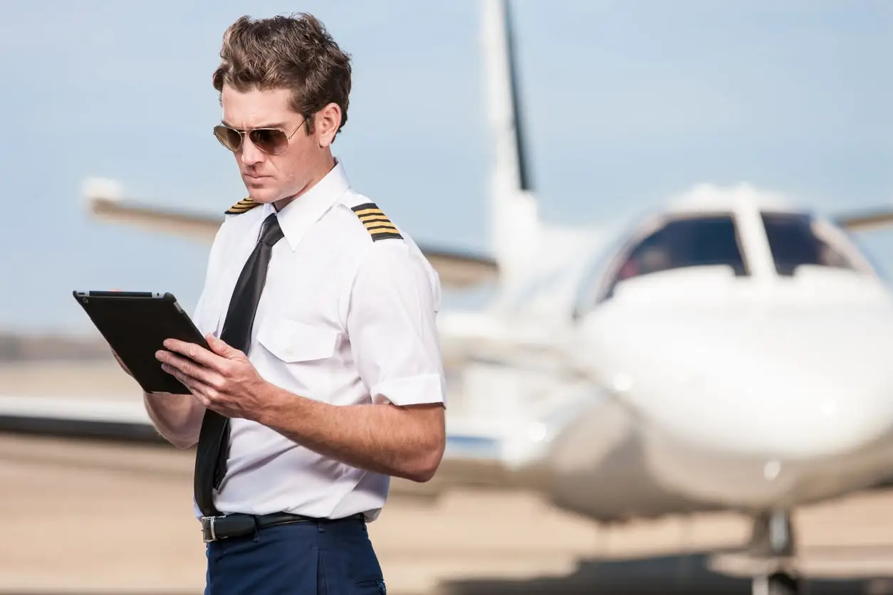 Certified flight instructor reviewing lesson plans on a tablet