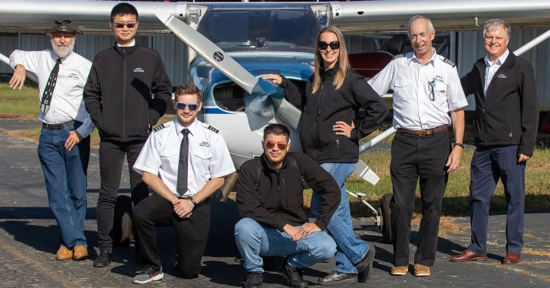 Triad Aviation Academy staff members standing with training aircraft at Piedmont Triad International Airport
