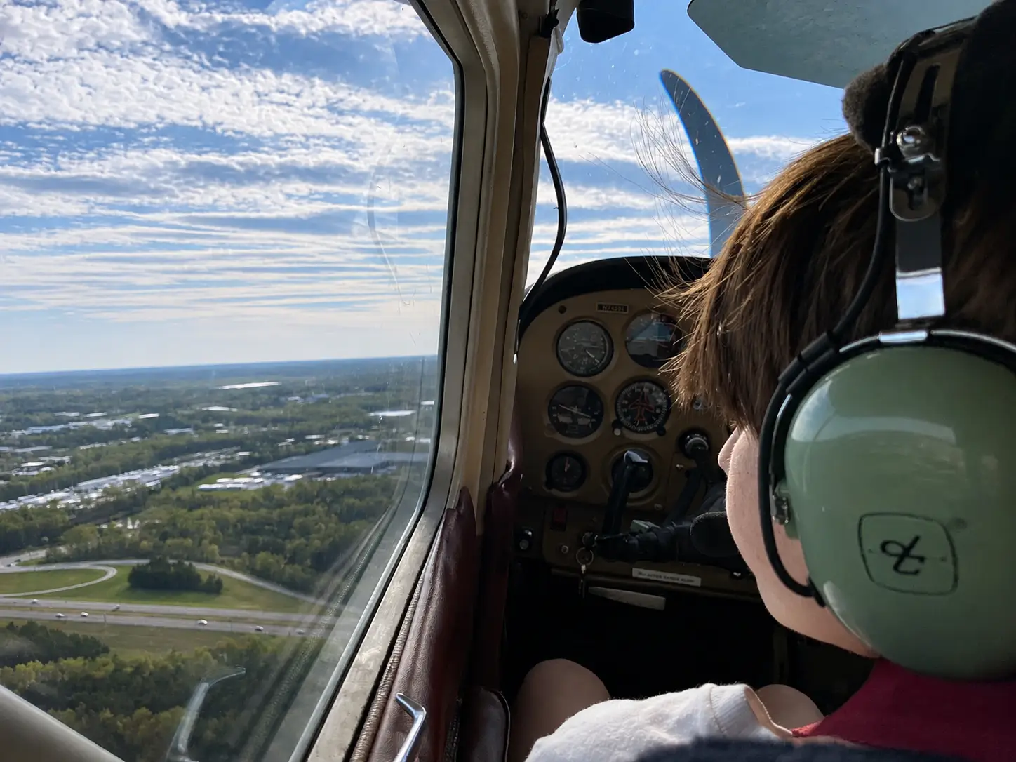 Young student pilot looking thoughtfully out of a Cessna window